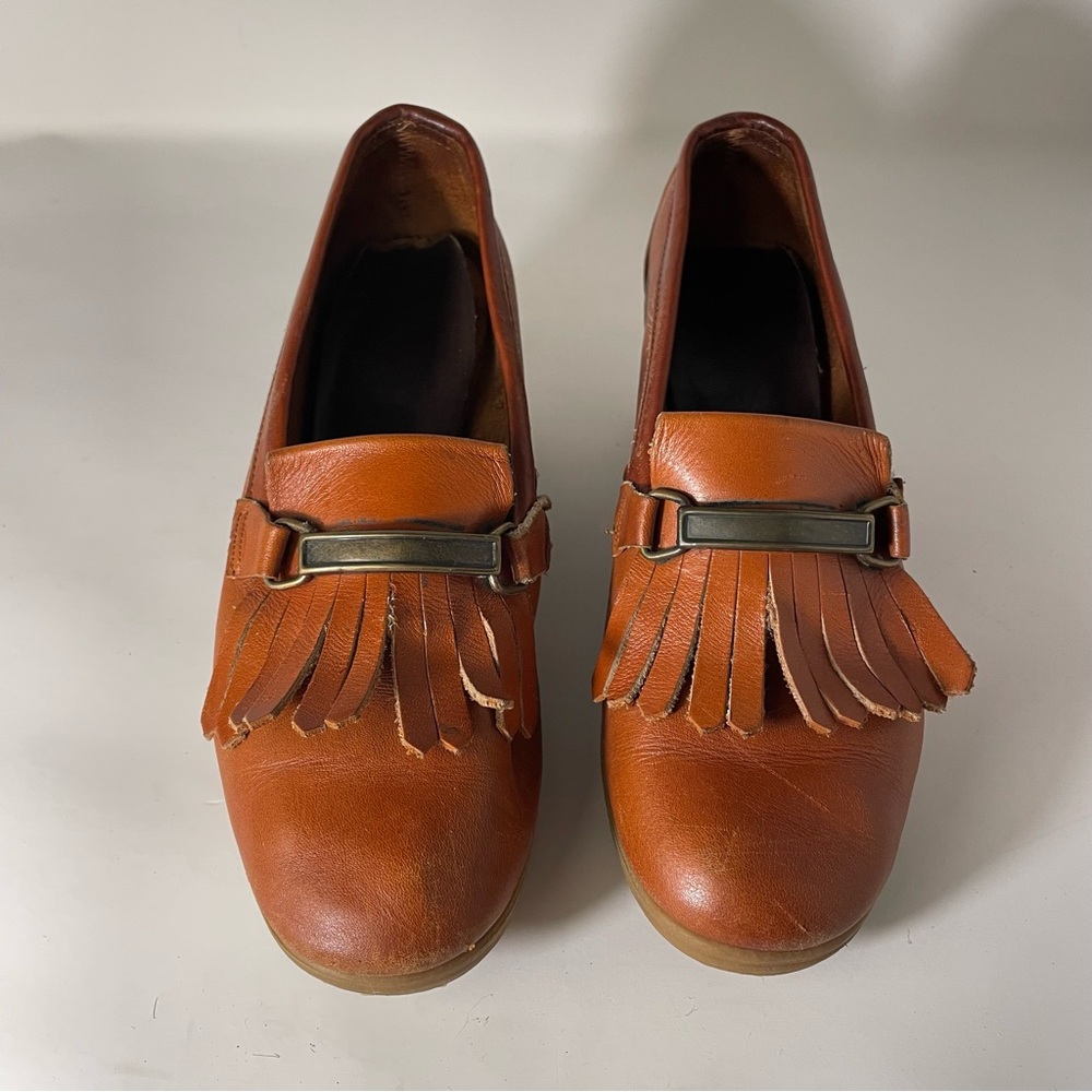 Brown leather fringe loafers with gum wedge heel